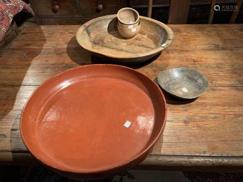 An Indian wood food bowl, 46cm diameter: A Burmese red lacquer circular bowl, 49cm diameter: four