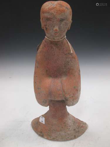 A Chinese red pottery standing lady attendant, probably Han Dynasty, 31.5cm high