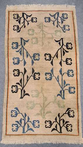 A harlequin pattern rug, 146 x 82cm; two pale ground Chinese rugs, 179 x 85.5cm & 174 x 92cm (3)