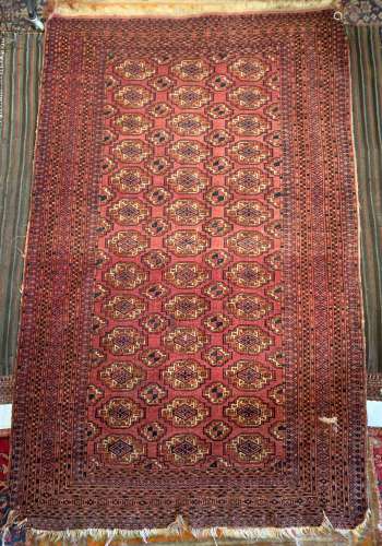 Two Bokhara wool rugs, 20th century, each with rows of medallions on maddder grounds, 108cm x 145cm,