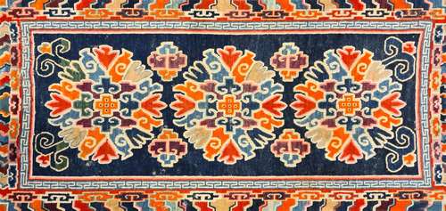 A Chinese woollen rug, circa 1930, 130 x 74.5cm; a woollen three medallion rug, possibly Tibetan,