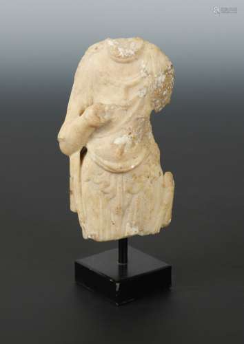 A Chinese white marble fragmentary torso of a Buddhist deity, in Sui Dynasty style, 14cm high
