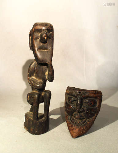 A carved wood seated figure, perhaps Africa or North American Indian, circa 1900 or later, with