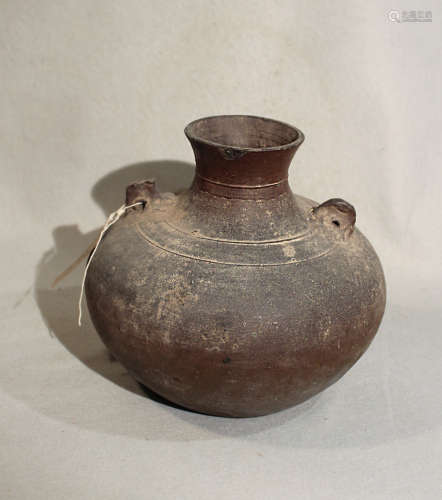 A Chinese brown glazed pottery vase, compressed with pierced tab shoulder handles, probably Liao