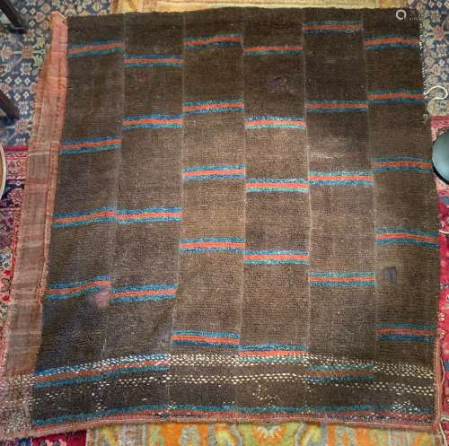 A Tibet wool nomadic rug, early 20th century, composed of six panels on cotton striped back, 147cm x