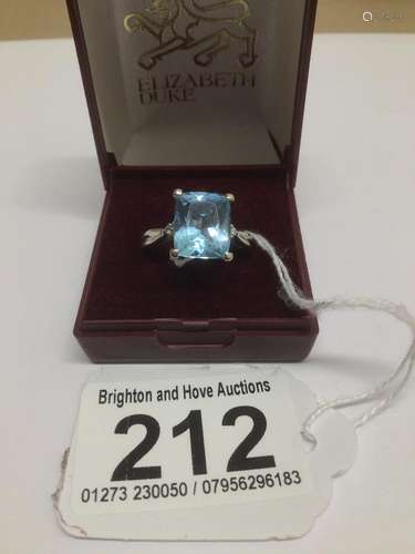 AN 18CT WHITE GOLD RING WITH A 12 X 10MM TOPAZ STONE WITH THREE DIAMONDS ON EACH SHOULDER SIZE S