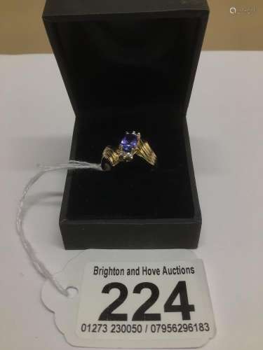 A 14CT YELLOW GOLD RING WITH AMETHYST AND SIX DIAMONDS SET IN PLATINUM SIZE M.5 3 GRAMS