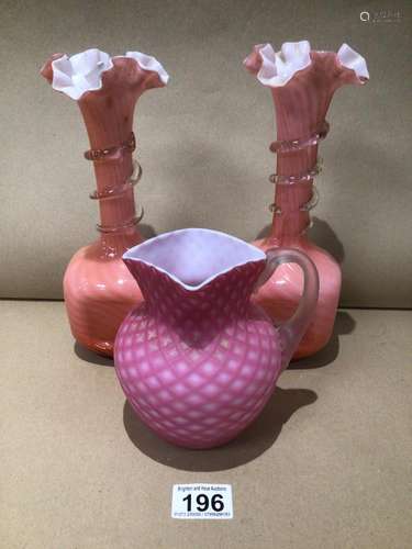 A VICTORIAN PINK SATIN GLASS MILK JUG AND A PAIR OF VICTORIAN PINK OVERLAY GLASS VASES 26CM HIGH