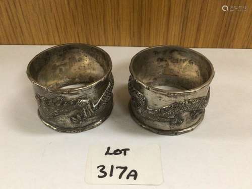 A PAIR OF CHINESE SILVER NAPKIN RINGS BY YOKSANG DECORATED WITH DRAGONS 73 GRAMS