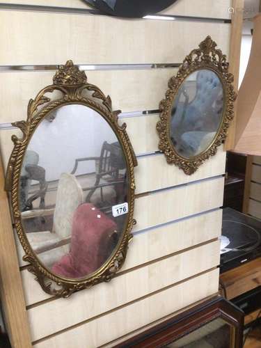 A PAIR OF VINTAGE ORNATE AND GILDED FRAMED MIRRORS OF OVAL FORM LARGEST IS 49 X 28CM