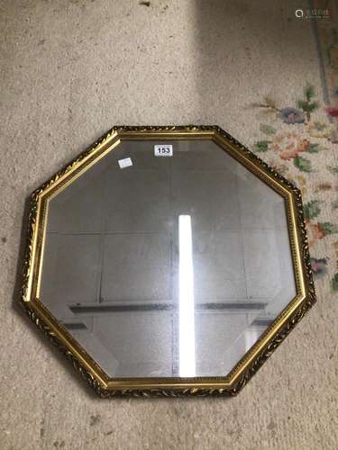 A GILDED OCTAGONAL SHAPED BEVELLED MIRROR 55CM DIAMETER