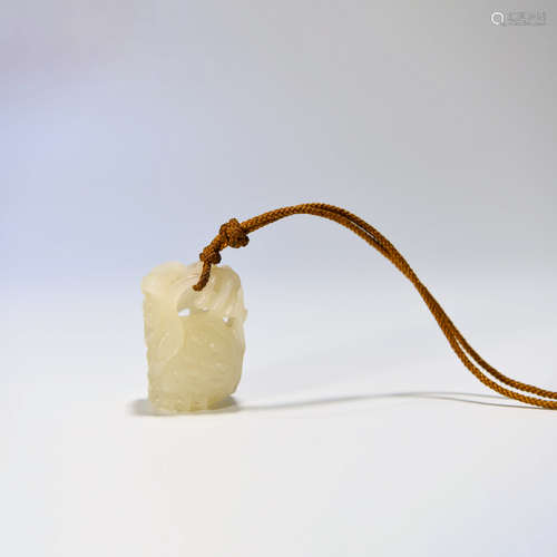 A HETIAN JADE CARVED LOTUS SEEDPOD PENDANT