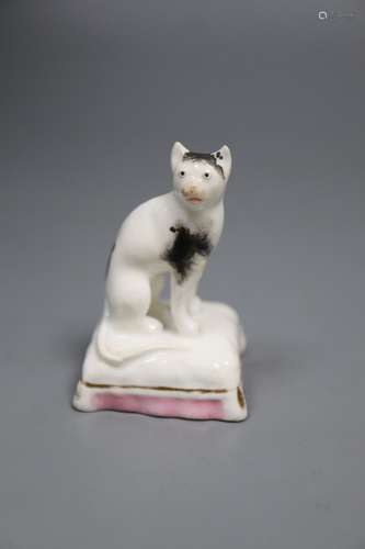 A rare Staffordshire porcelain figure of a cat seated on a cushion, c.1835-50, 6cmCONDITION: Typical