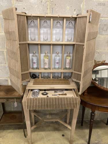 A Christopher Coane design British oak spirits cabinet, supplied with British spirits glassware