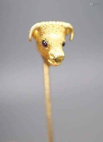 An Edwardian yellow metal and garnet set 'bull's head' stick pin, 65mm, gross 4.4 grams.CONDITION: