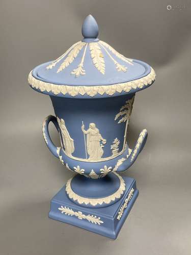 A 20th century Wedgwood light blue jasperware two-handled campagna-shaped urn and cover, decorated