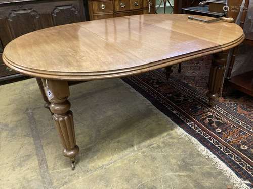 A Victorian mahogany oval extending dining table, with two spare leaves, 220cm extended, width