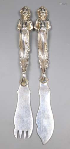 A pair of late Victorian silver fish eaters with figural handles by Goldsmiths & Silversmiths Co