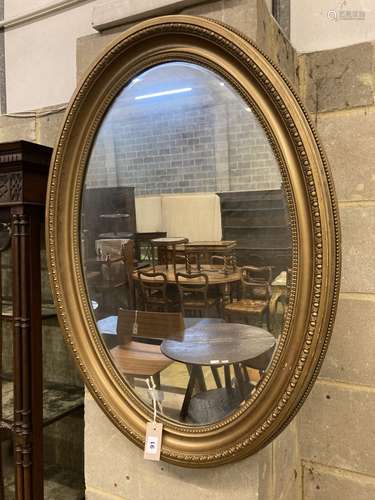 An oval gilt framed wall mirror, width 62cm, height 87cm