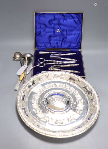 An Eastern embossed plated tray, a cased plated nut and grape set, a plated coffee pot, a silver