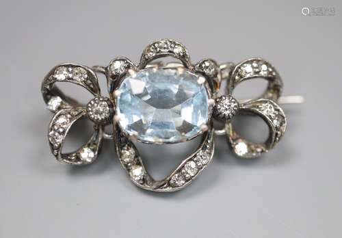 An Edwardian white metal, aquamarine and diamond set scroll brooch, 25mm, gross 3.8 grams.CONDITION: