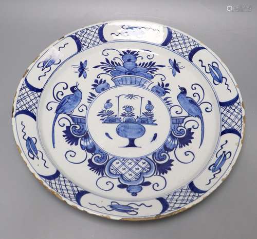 An 18th century blue and white Delft charger, 35cmCONDITION: Shallow chips and flakes to rim, no