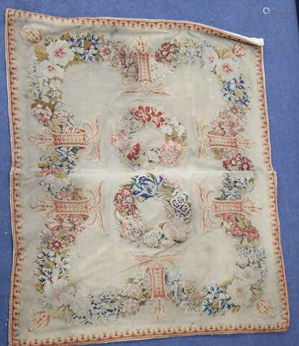 An Antique French needlepoint panel, decorated with a continuous band of flowers and two central