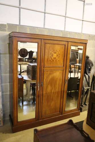 An Edwardian satinwood banded and inlaid mahogany triple wardrobe with fitted interior, width 175cm,