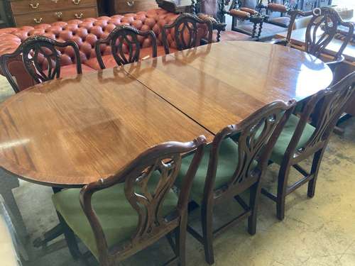 A set of seven George III style mahogany dining chairs (one with arms) together with a mahogany twin