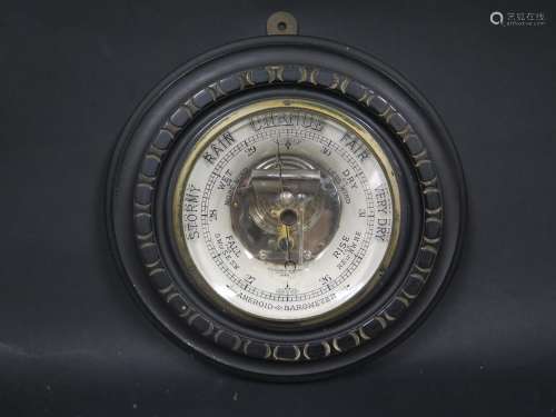 A Victorian Aneroid Barometer in an ebonised case, patent no. 2526 applied for 1888, 23cm diam.