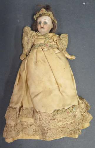 A German Porcelain Headed Doll with composite arms and legs