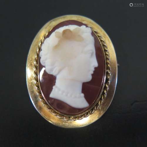 A Carved Hardstone Cameo Brooch decorated with a female bust and in an unmarked gold setting,