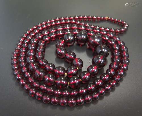 A Faux Red Amber Graduated Bead Necklace, c. 122cm long, largest bead c. 17mm, 62.5g