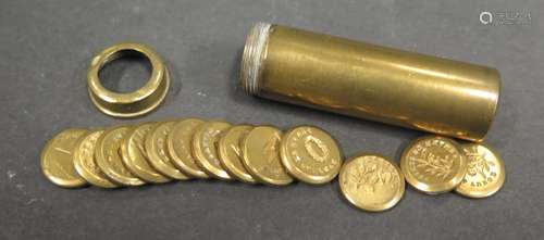 A Brass Cylinder containing thirteen 12.5mm discs engraved with symbols and French and English