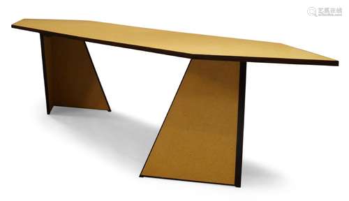 Andrew Kindler, a modern chipboard dining table, of recent manufacture, the shaped top on two