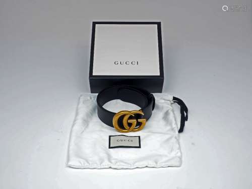 A Gucci GG leather belt, designed with characteristic 'GG' logo antiqued brass buckle, to a black