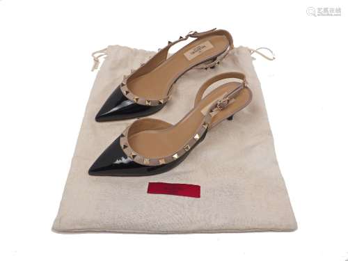 A pair of Valentino Garavani 'Rockstud' patent leather slingback pumps, designed in black and '