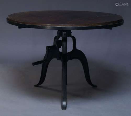 An Industrial style breakfast table, of recent manufacture, the circular veneered top on cast iron