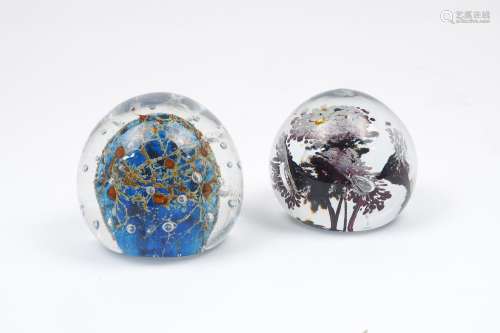 Two paperweights of modern design, the former with blue and orange centrepiece and glass bubbles,