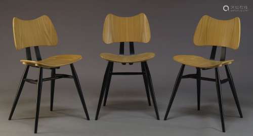 Ercol, a set of three beech and ebonised 'Butterfly' chairs, together with a set of four modern