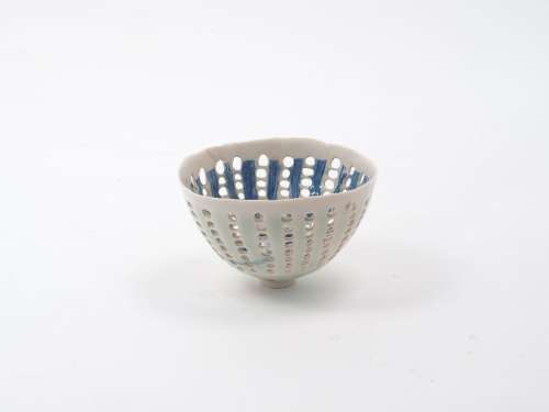 Dorothy Fiebleman (1951-), A small openwork bowl of cream ground with blue decorative designs to the