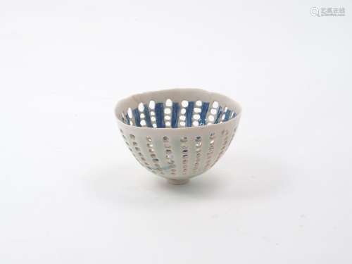 Dorothy Fiebleman (1951-), A small openwork bowl of cream ground with blue decorative designs to the