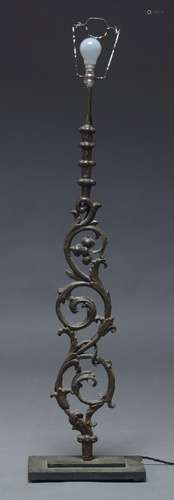 A Victorian cast iron scrolling foliate section of railing, later mounted and converted to a lamp,