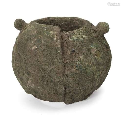 A Chinese bronze bangle, Neolithic period, of broad, rounded form, heavily encrusted and with traces