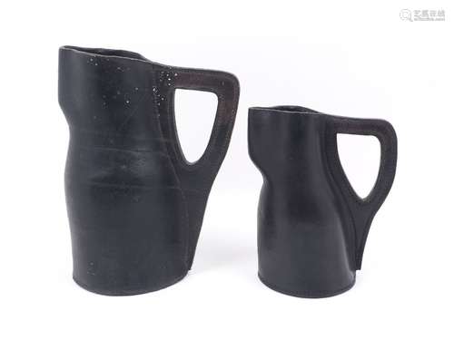 A late 19th century leather 'black jack' jug, with right angled handle and circular base, 30cm high,