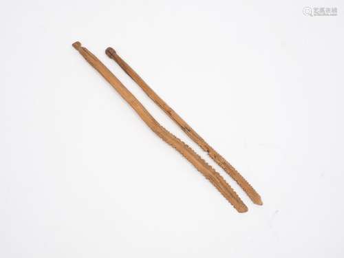 A pair of carved softwood tally sticks of indeterminate age, of thin rectangular form terminating