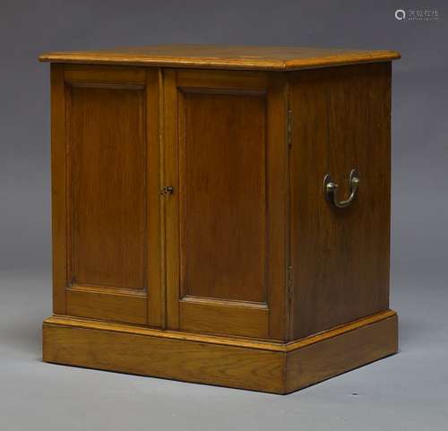 A Victorian oak specimen cabinet, enclosing 60 fitted drawers, with brass carrying handles to each