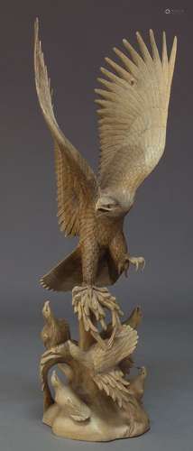 A pair of modern carved wood sculptures, designed as a landing eagle to awaiting fledglings all atop