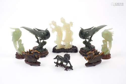 A group of jadeite and hardstone carvings on carved and pierced wood stands, to include a pair of