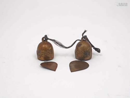 A pair of Thai bronze bells, each of typical domed form, designed with Phaya Naga relief to the